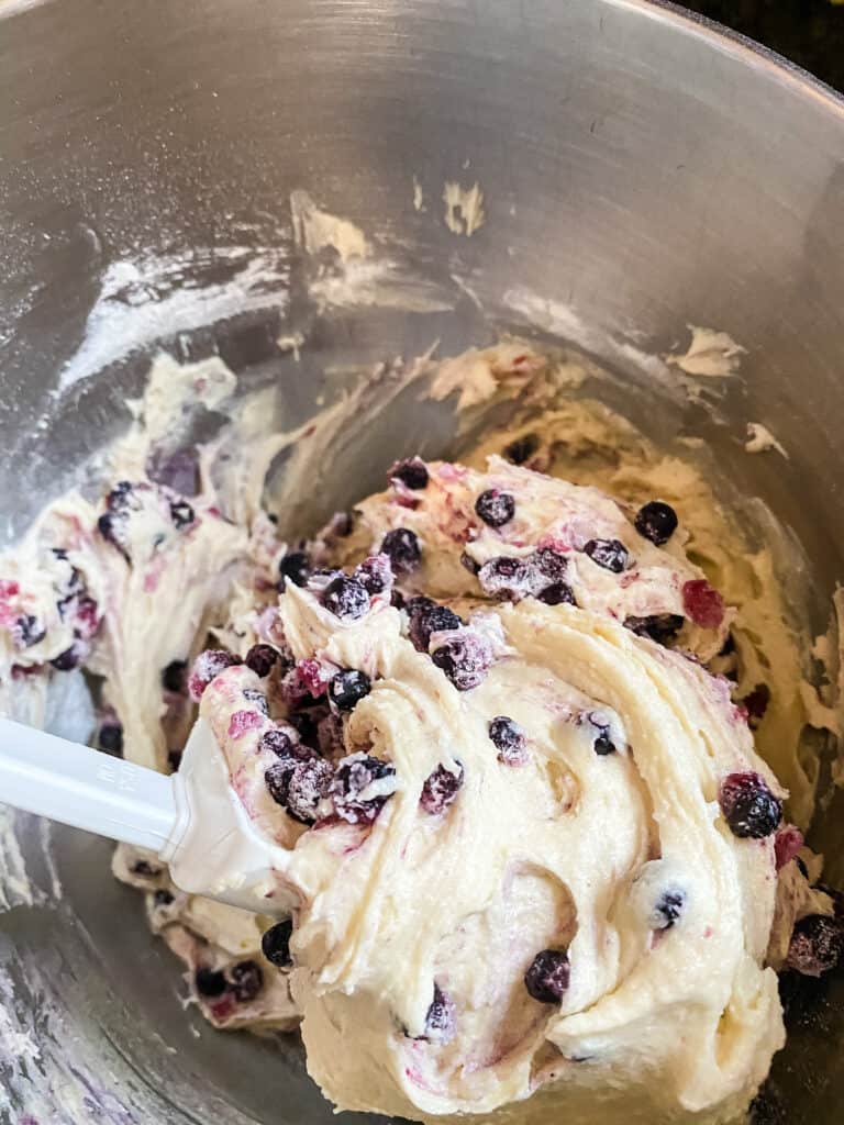 folding blueberries into batter