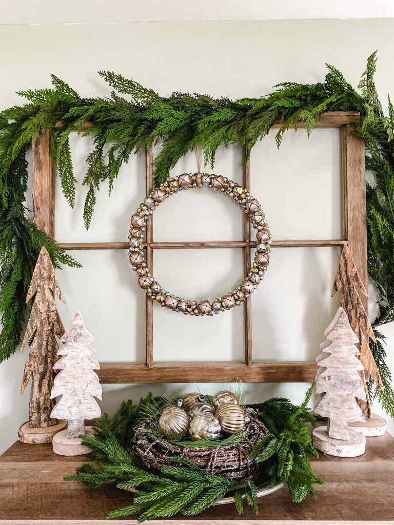 window frame with jingle bell wreath and wood trees
