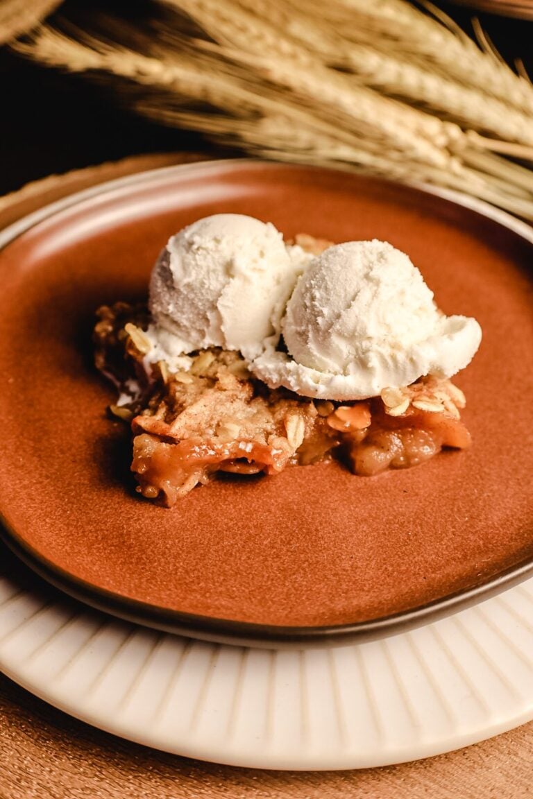 plate of apple crisp with vanilla ice cream