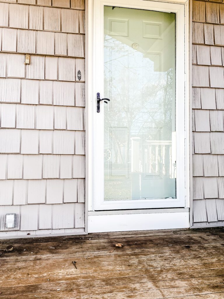 gray house with blue door
