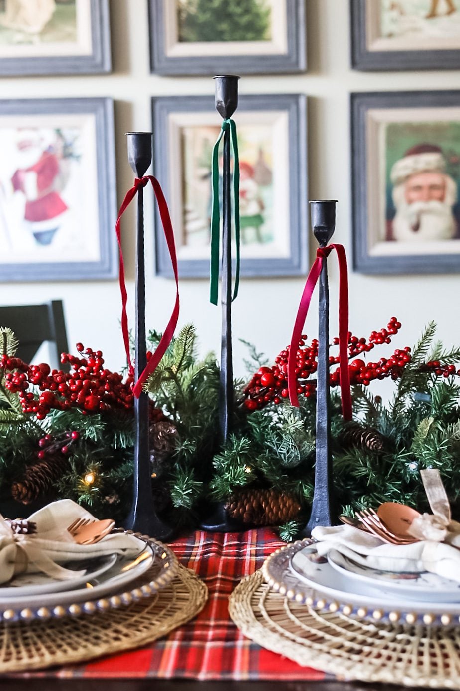 A table set for Christmas with black candle tapers.