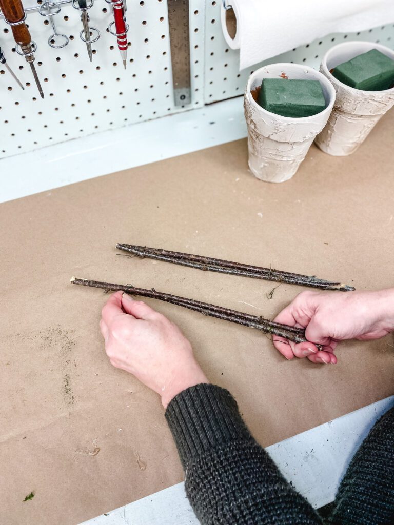 taping branches together to make a topiary