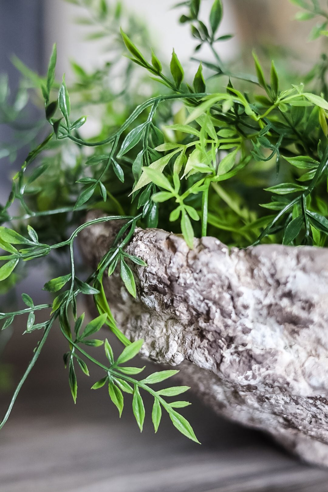 close up picture of a paper mache bowl and greenery