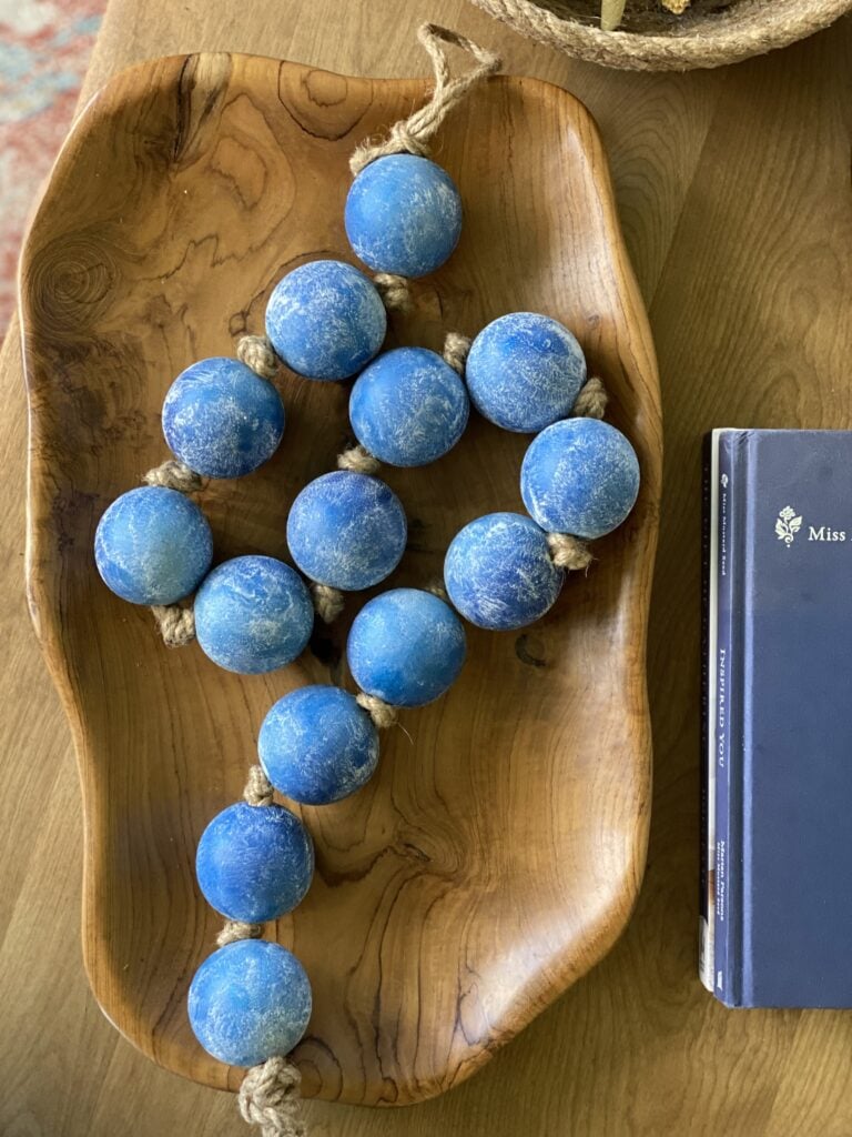 blue beads in a wood dish