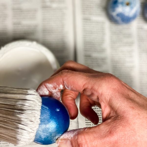 a hand and a paintbrush