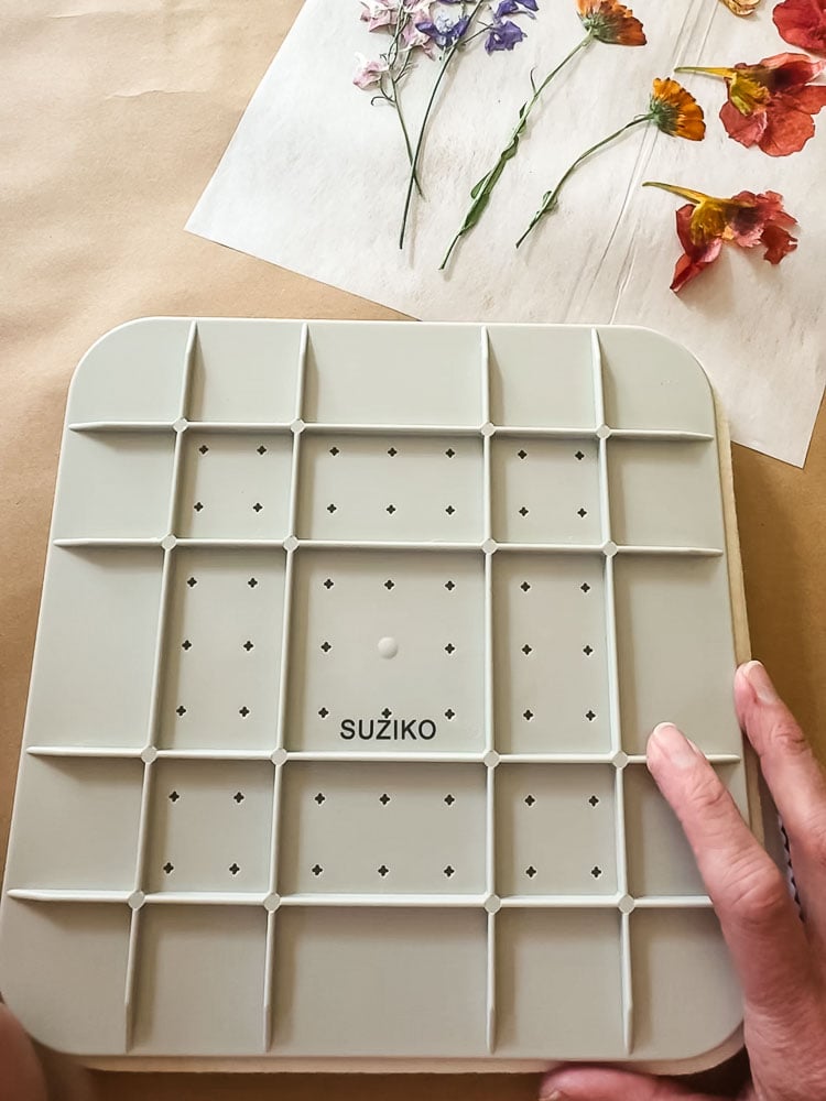microwave flower press with woman's hand touching top