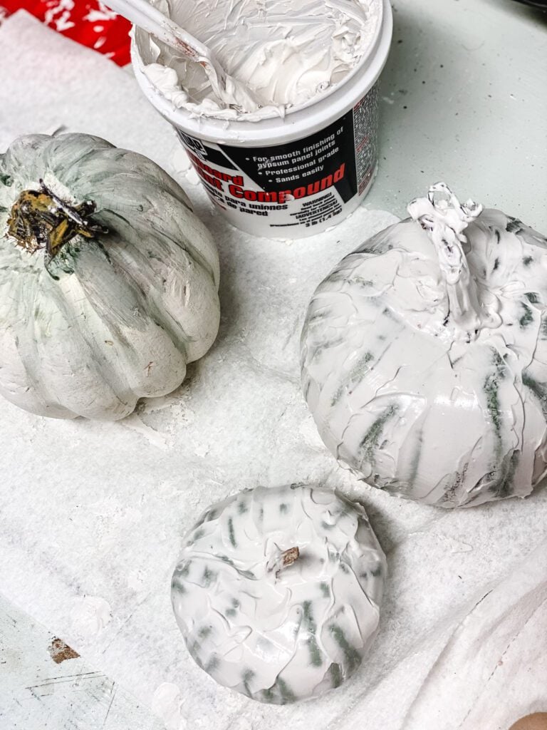 pumpkins being covered with joint compound