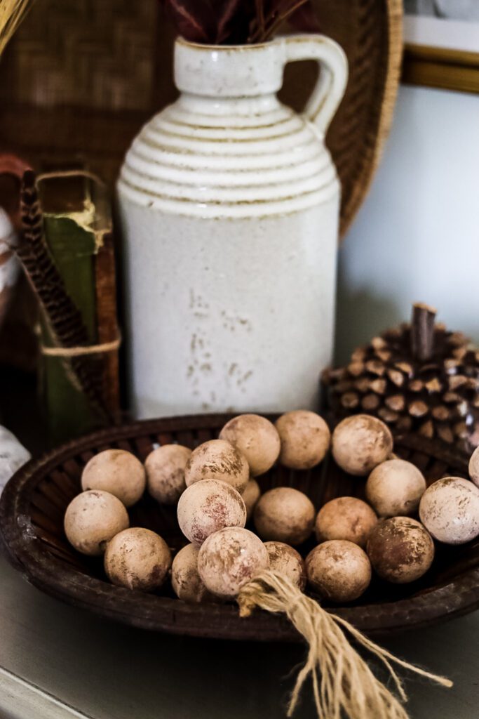 basket of beads, white jug and pumpkin