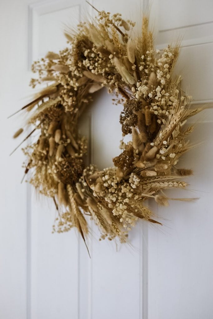 dried flower wreath hanging on door