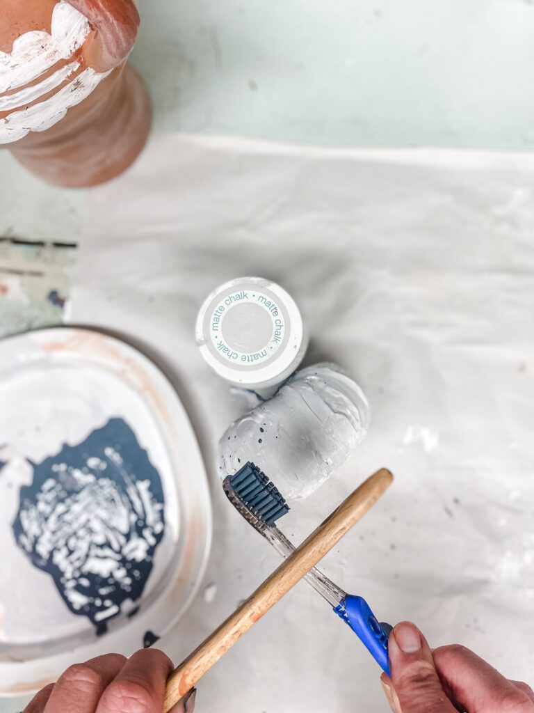 painting a foam pumpkin to look like cement