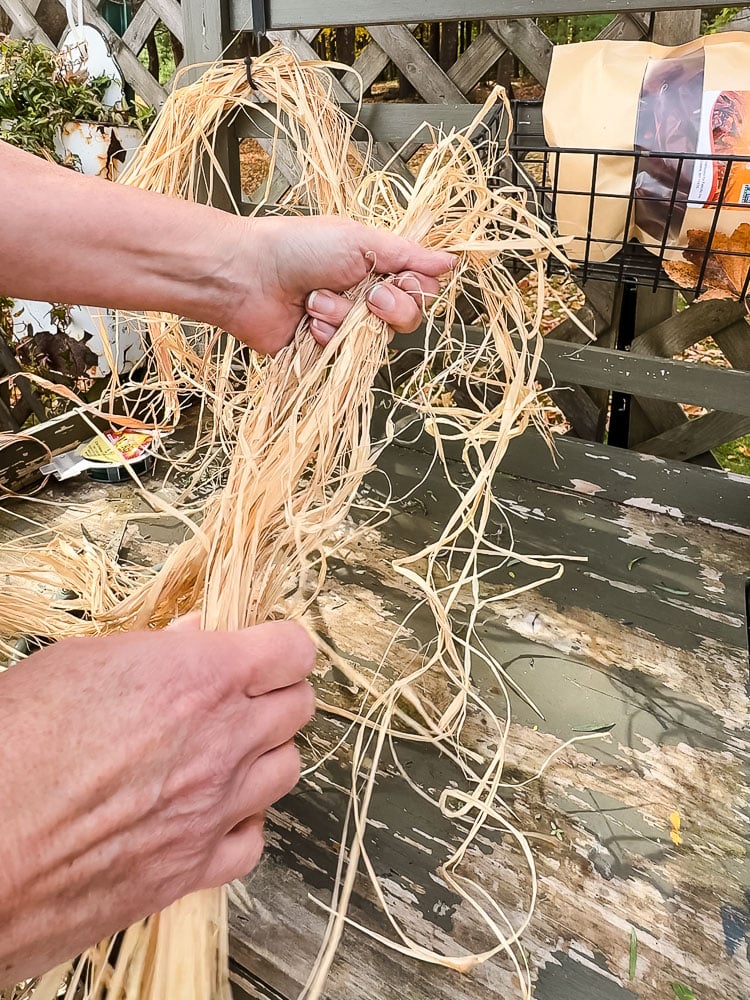 woman gathering raffia bunch