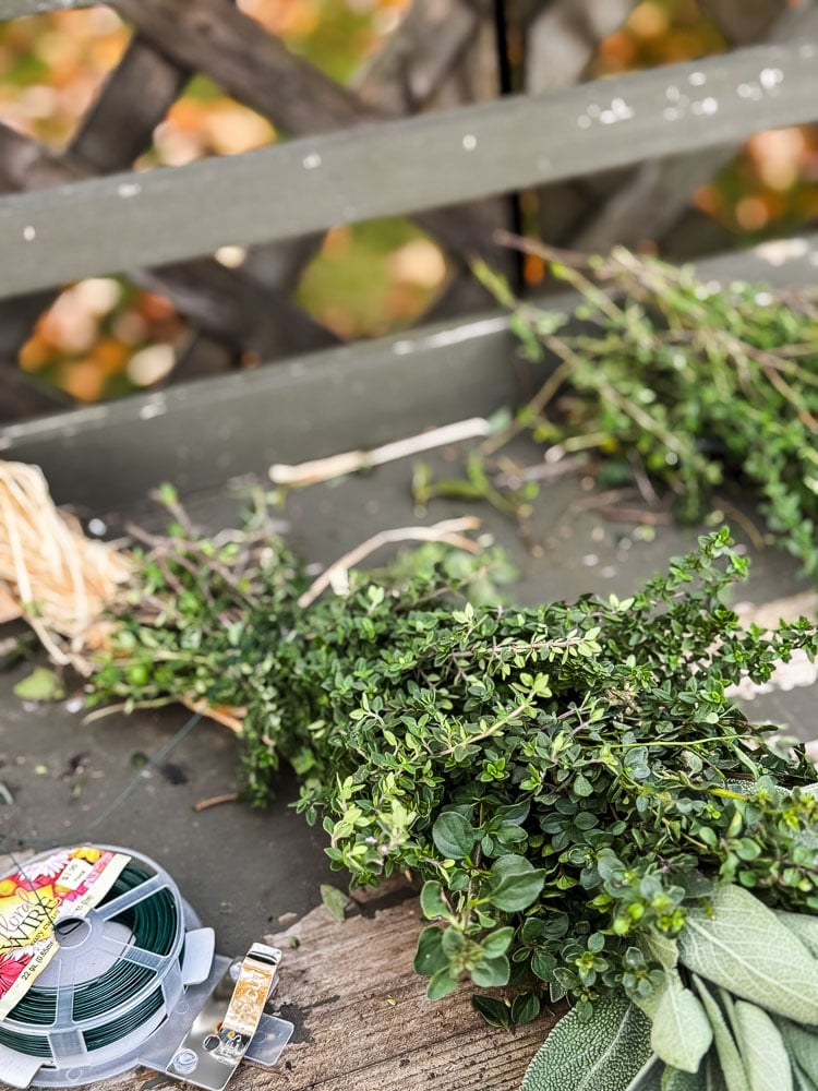 a fresh herb swag on a potting bench