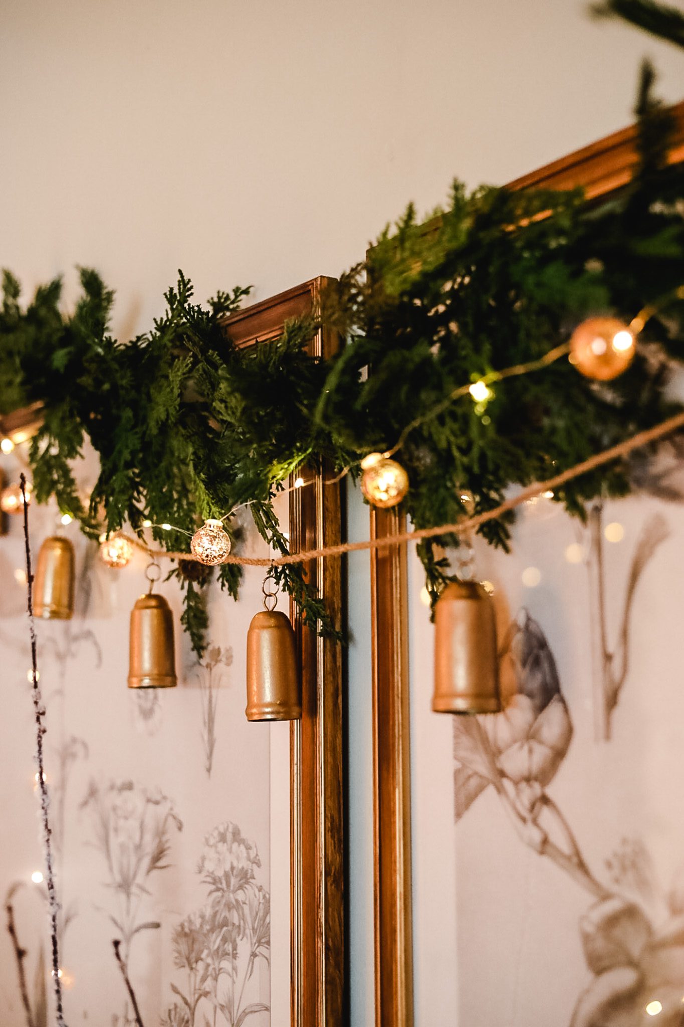 bells and garland hanging across wall art