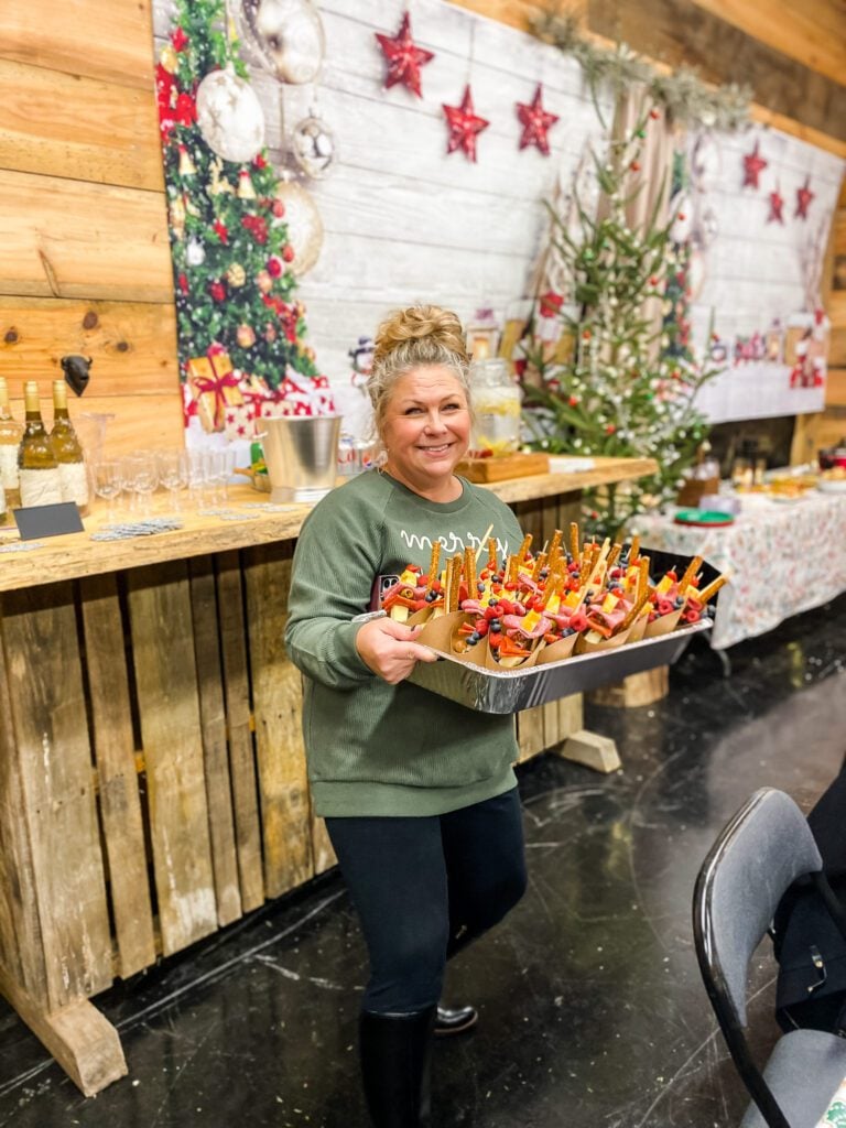 woman holding tray of appetizers in a rustic barn setting