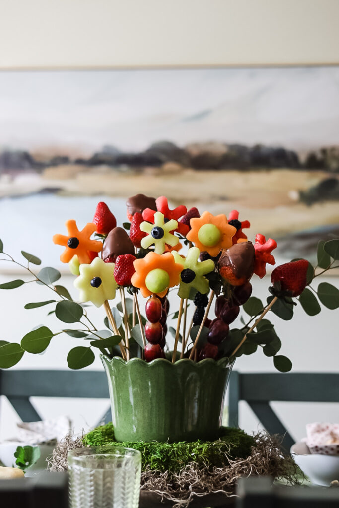 DIY edible fruit arrangement and fruit flowers in a display.