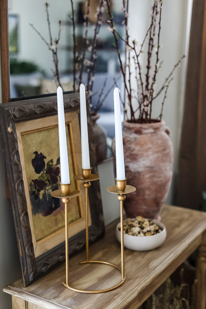 gold modern candlestick holder on entryway table