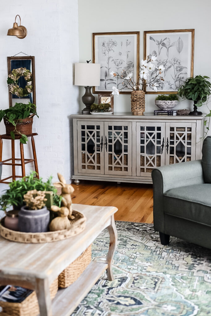 living room with console cabinet with lamp and flowers