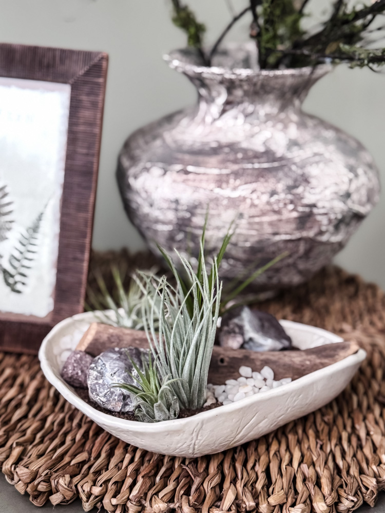 air plant dish, vase, frame on woven mat