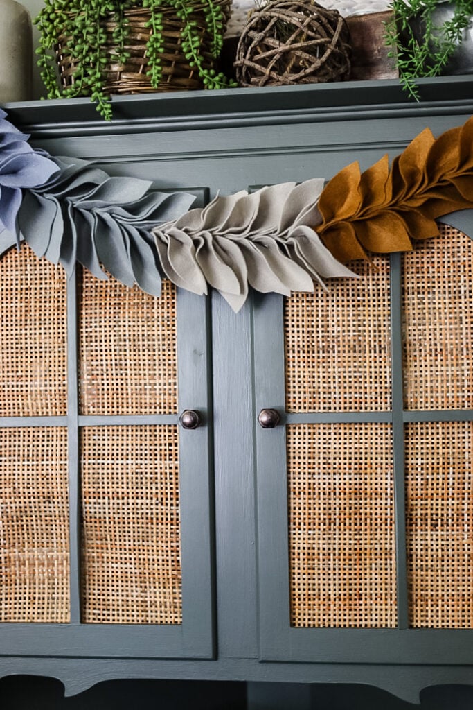 felt leaf garland hanging on cabinet