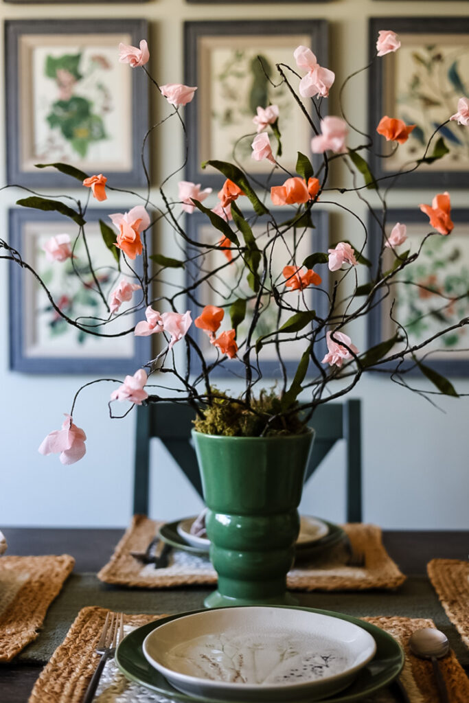 dining table with pretty green vase of paper cherry blossoms