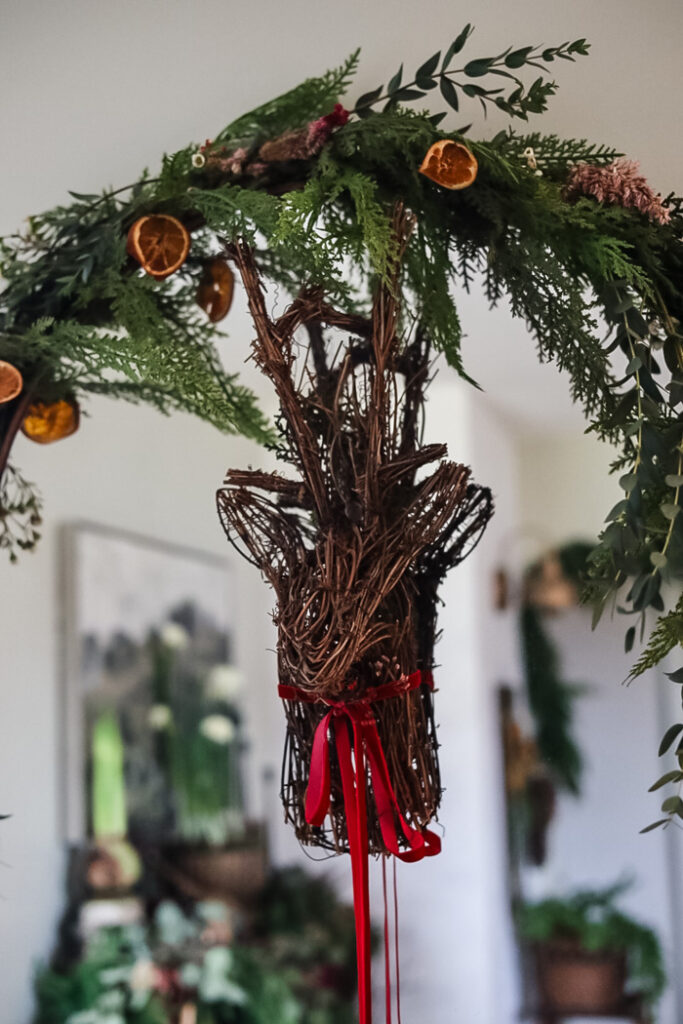wicker deer head hanging on a mirror