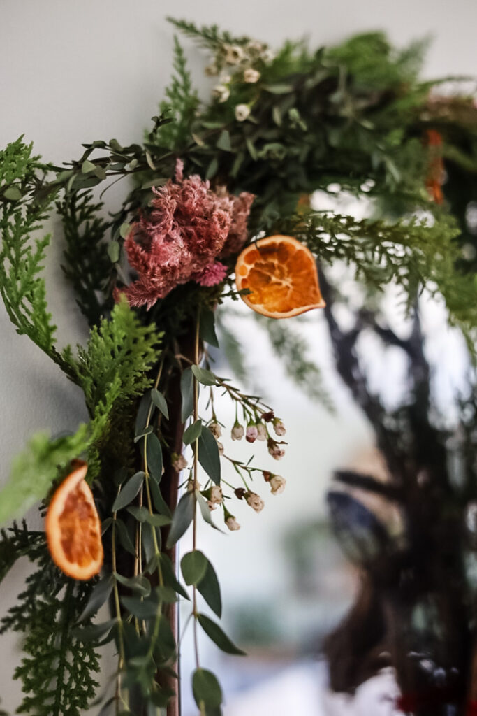 cedar garland with oranges and flowers