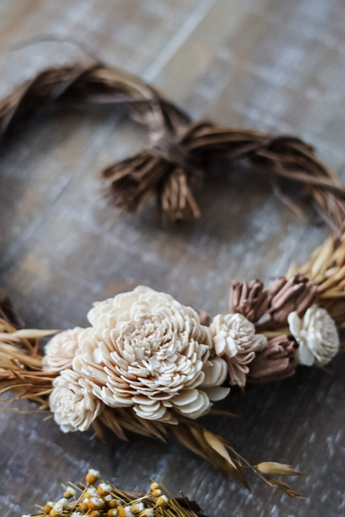 detailed image of a heart wreath with white sola flowers