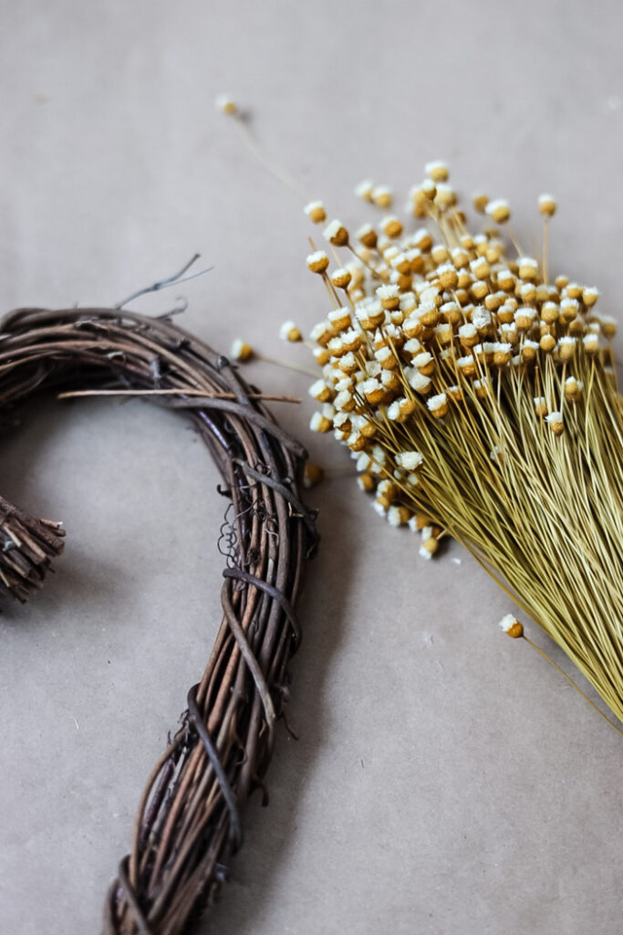grapevine heart wreath with bunch of dried flowers
