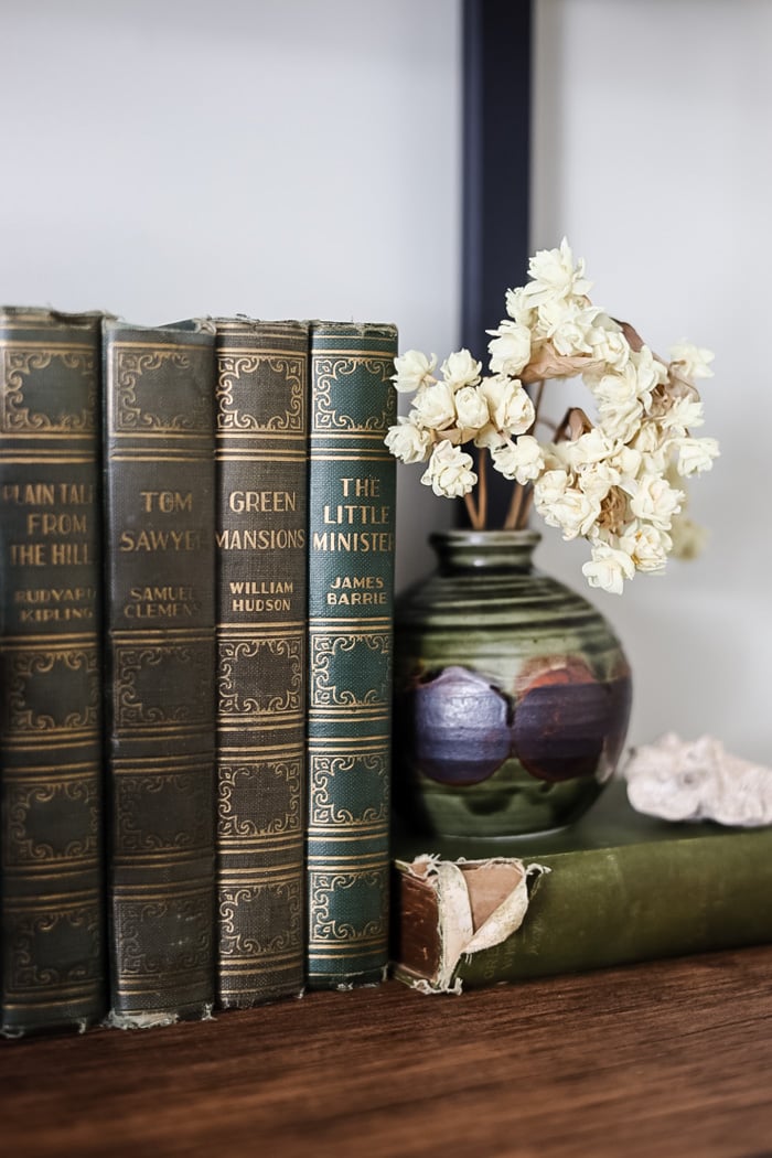 small green vase with white dried flowers