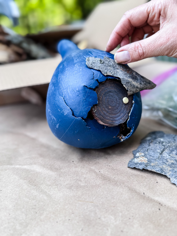gluing bark onto a fairy house