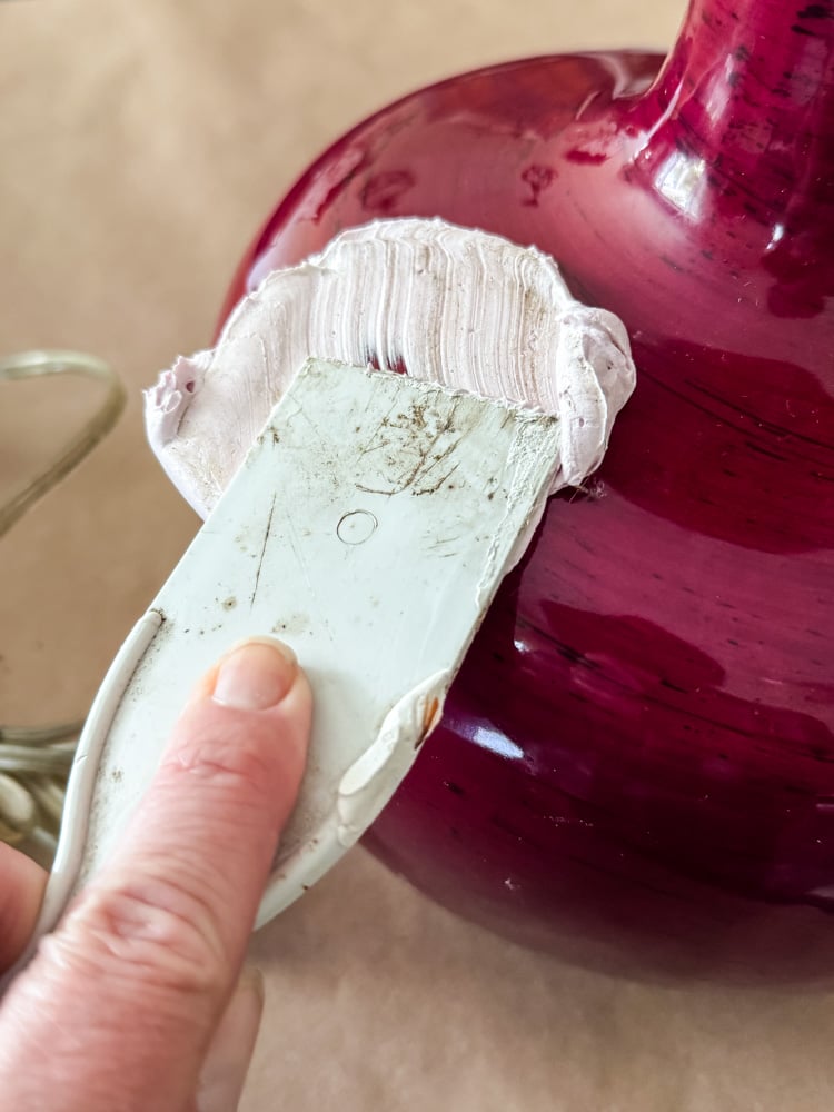 spreading joint compound onto a lamp