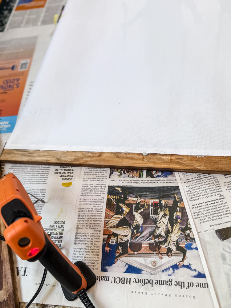 process of gluing wood strip to canvas