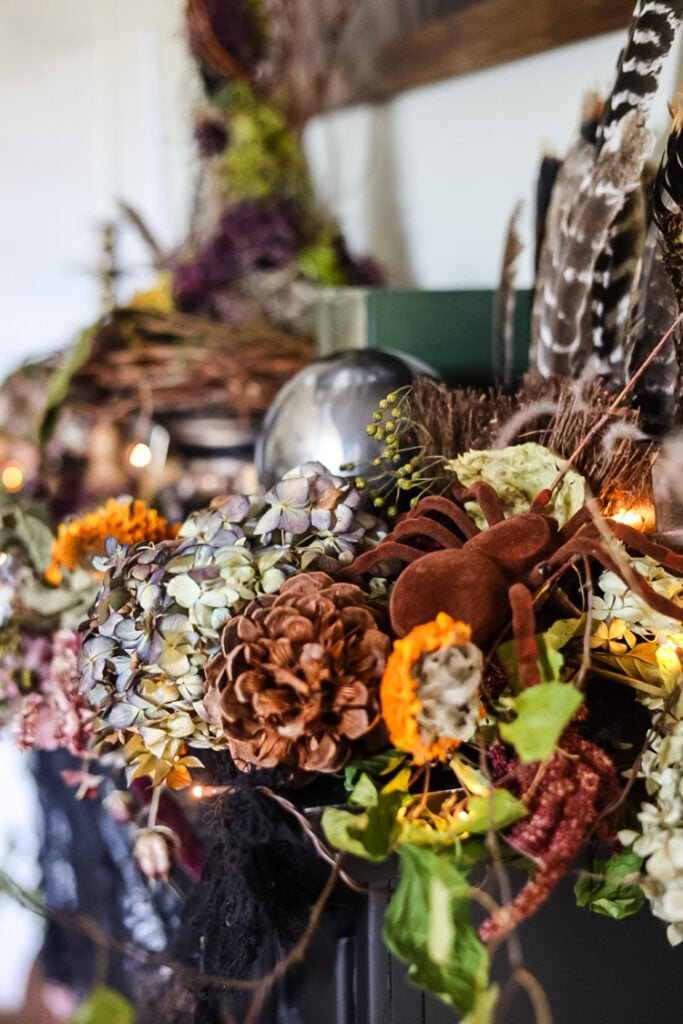 fall witch themed mantle with flowers