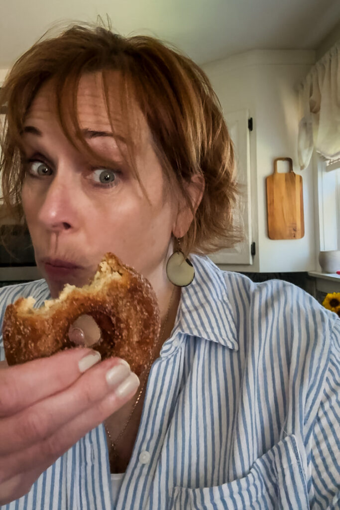Jennifer Howard enjoying a fresh apple cider donut