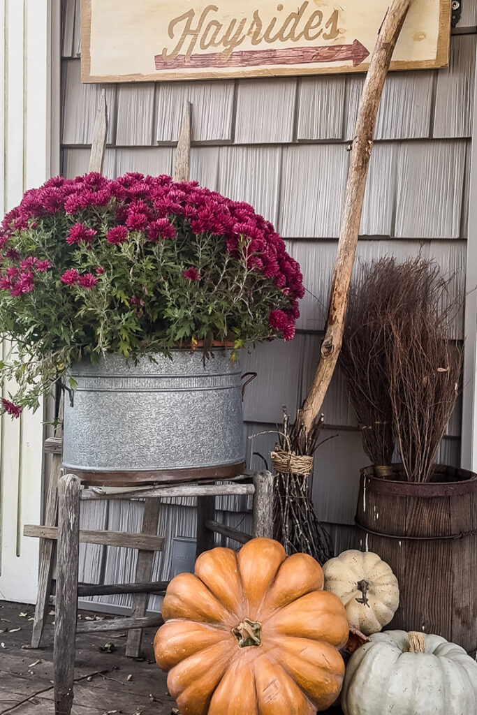 fall porch with mums and pumpkins