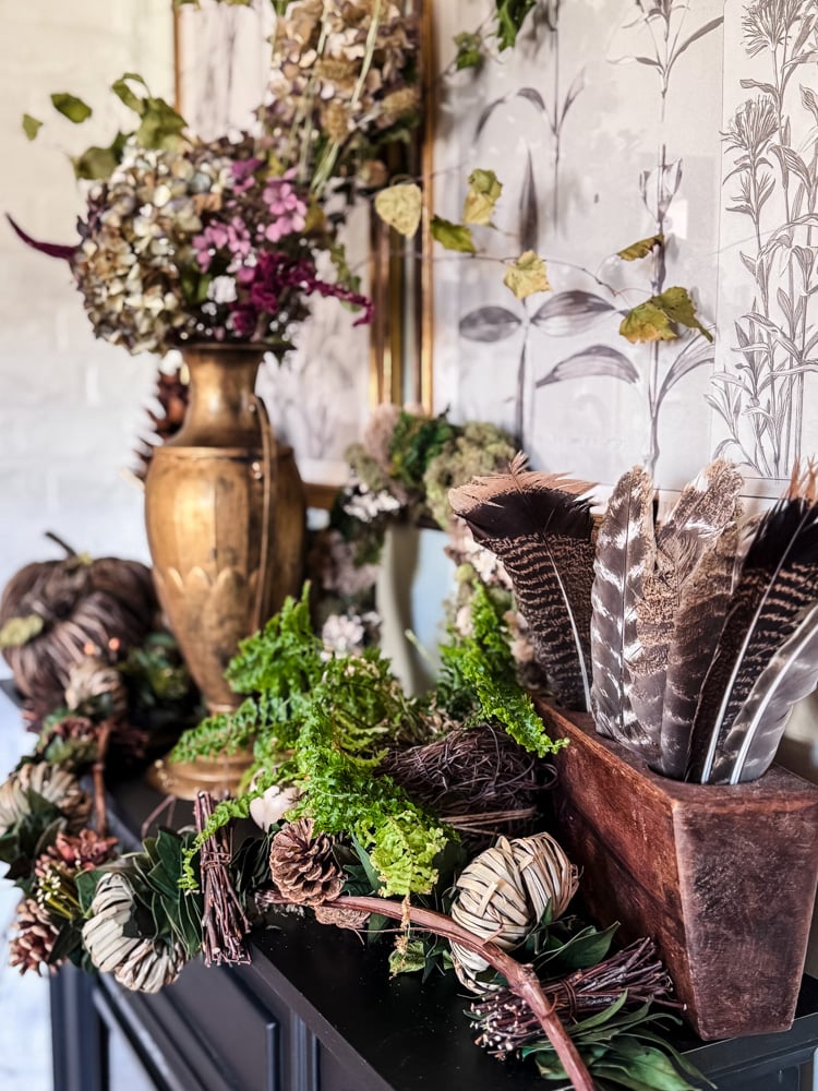 mantel deocrted for Fall with flowers and feathers