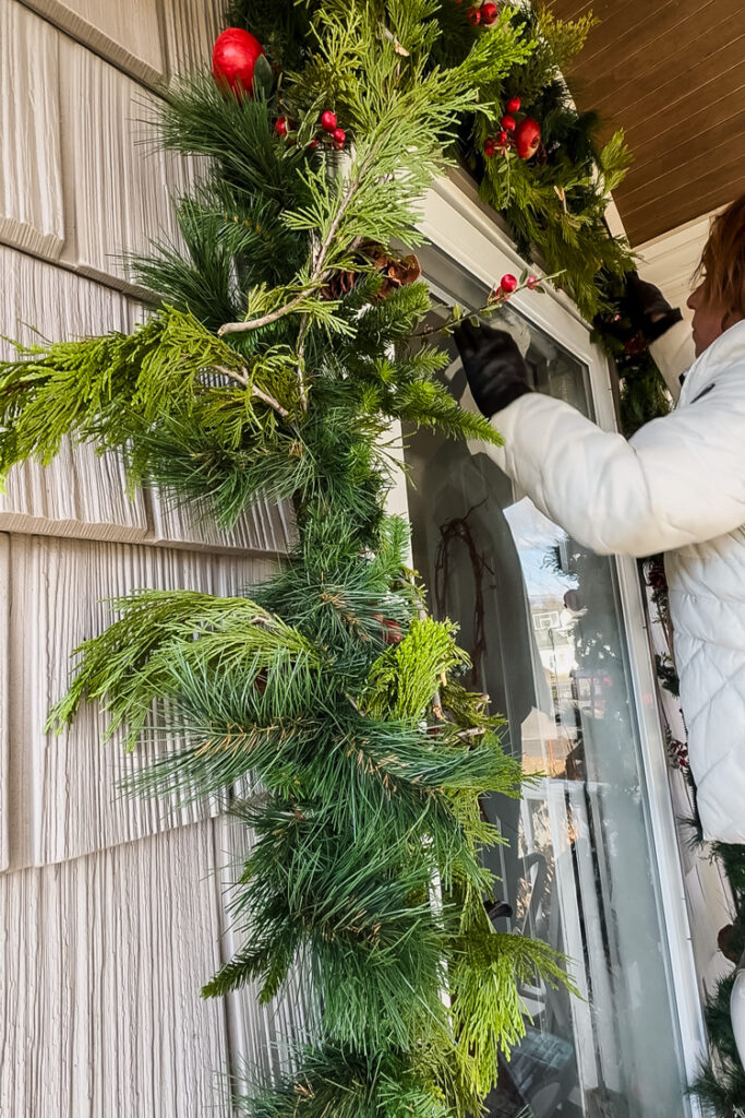 hanging garland around front door using vinyl siding hooks