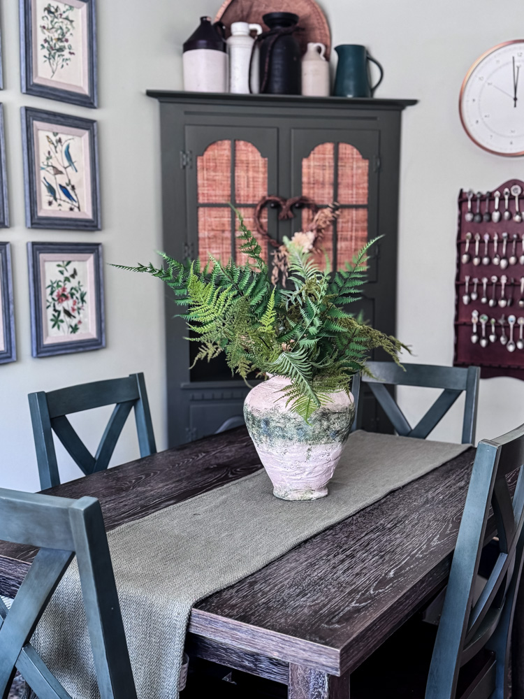 dining room table with vase of ferns