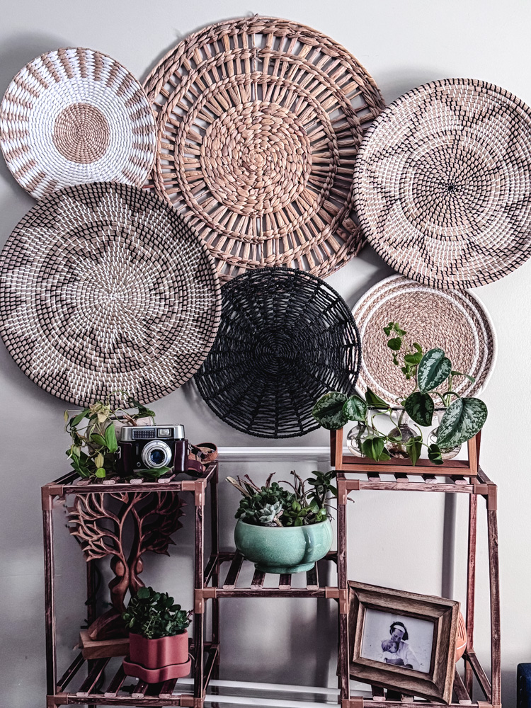 a basket wall with a plant stand beneath