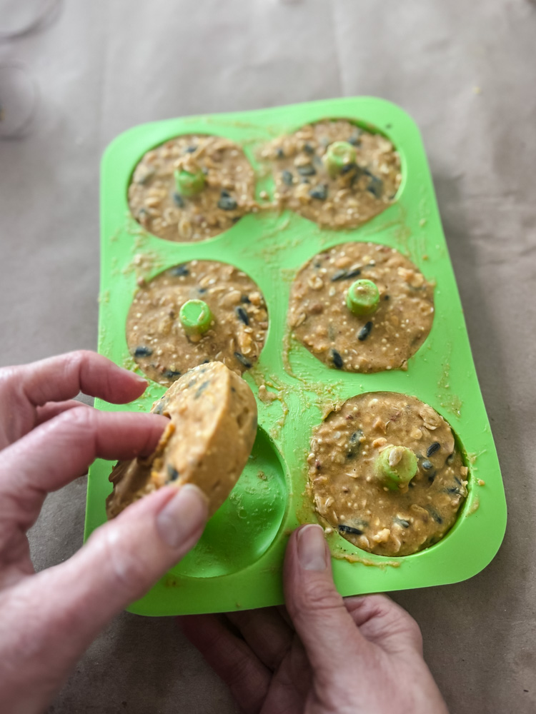popping out homemade suet cake rings from a mold