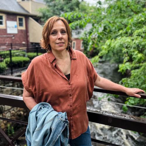 Photo of woman standing on bridge