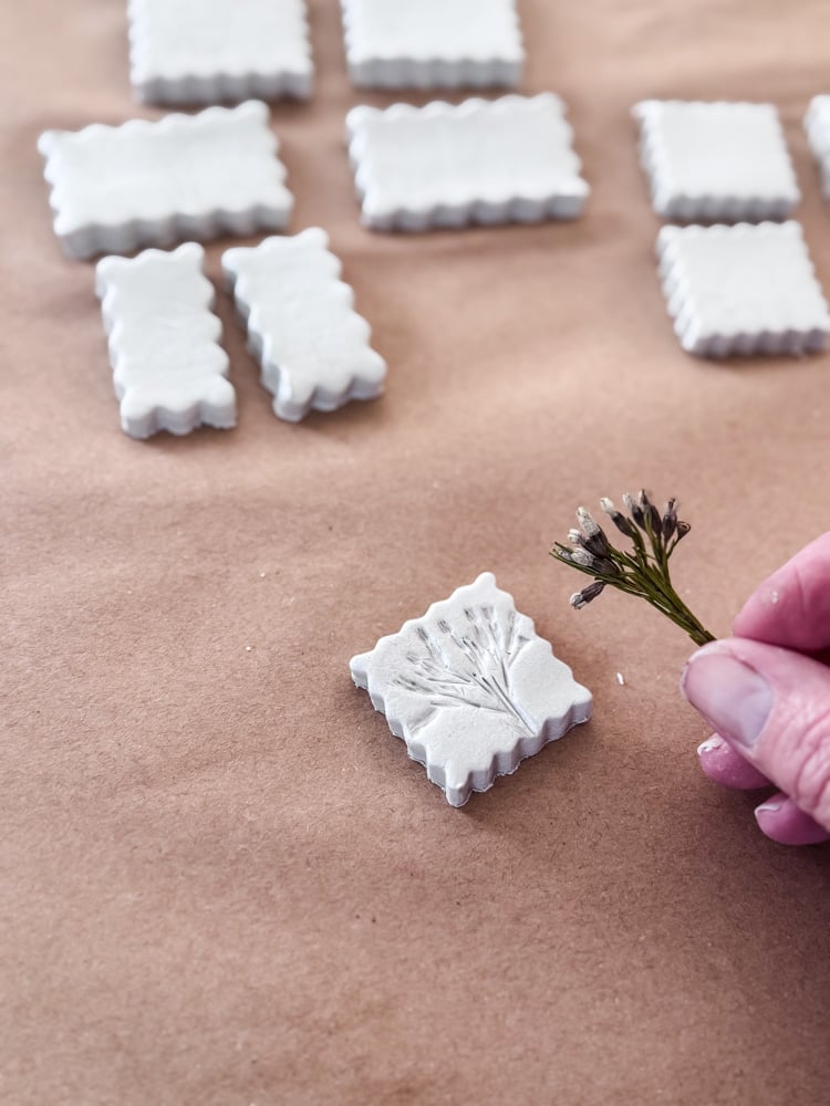 lifting a small flower from clay