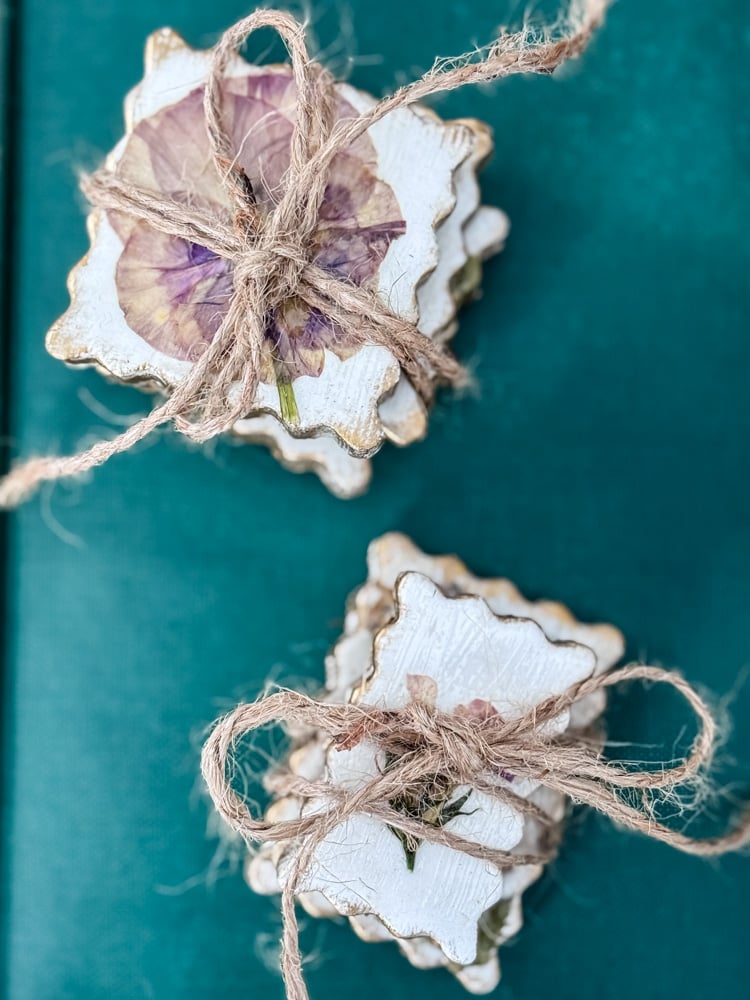 bundles of pressed flower postage stamped shape magnets tied with twine
