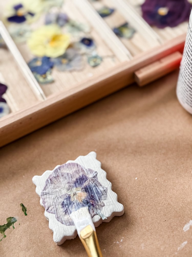 mod podge over pressed pansy on clay shape