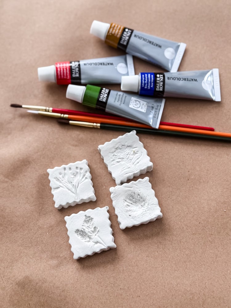 clay flower magnets and watercolor paint tubes