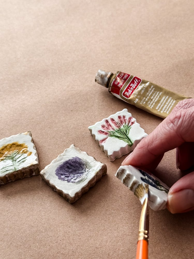 brushing rub and buff on a clay magnet