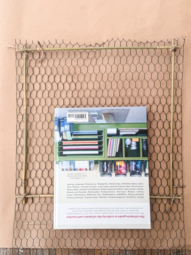 chicken wire frame being held in place by book