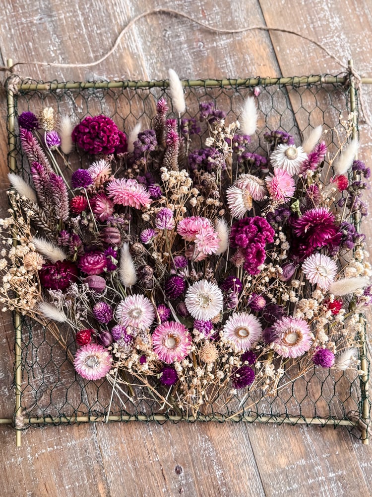 overhead photo of a frame filled with a dried flower bouquet