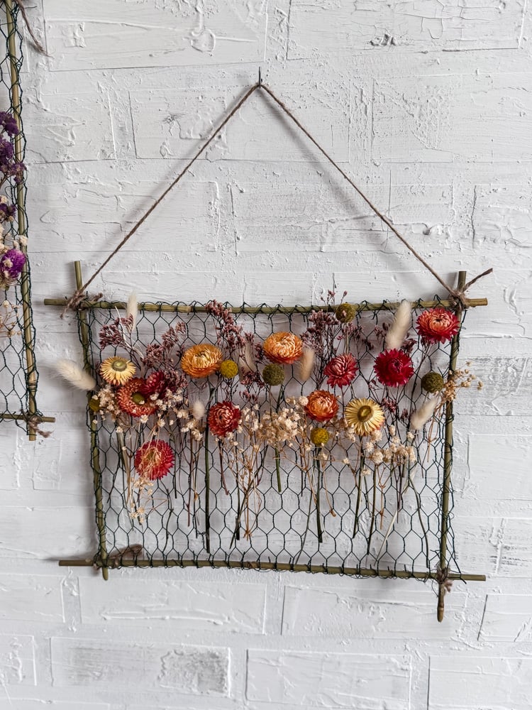 orange dried flowers in a hanging frame
