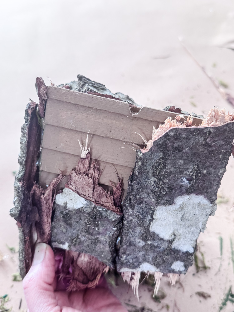 gluing bark on a birdhouse